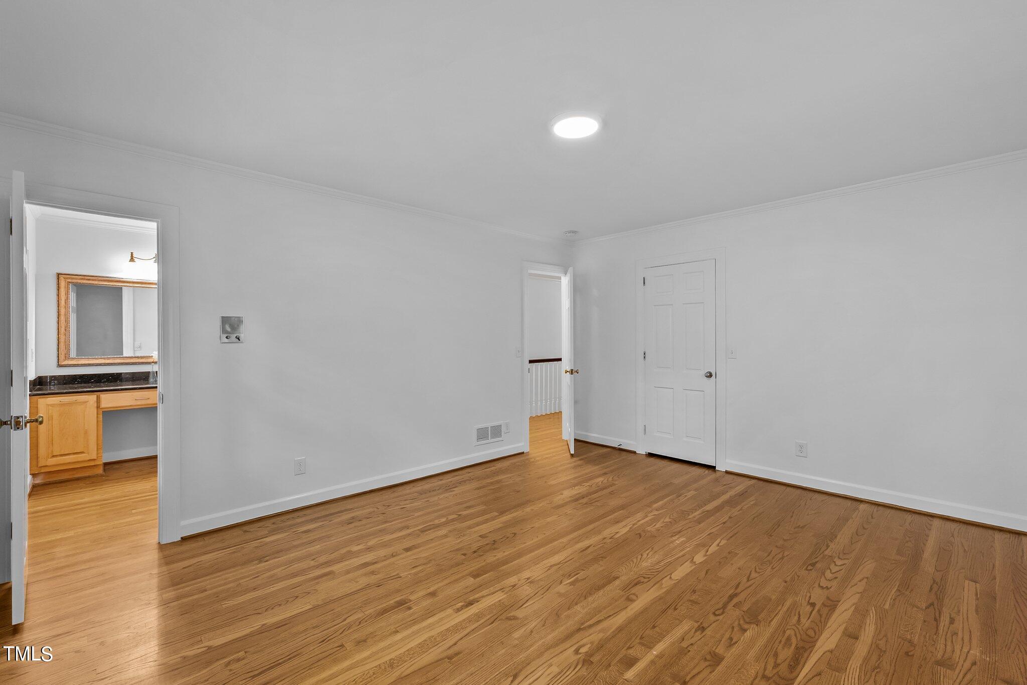 1817 Stillwater Drive Raleigh, NC 27607 - Photo 25 of 58 a view of empty room with wooden floor