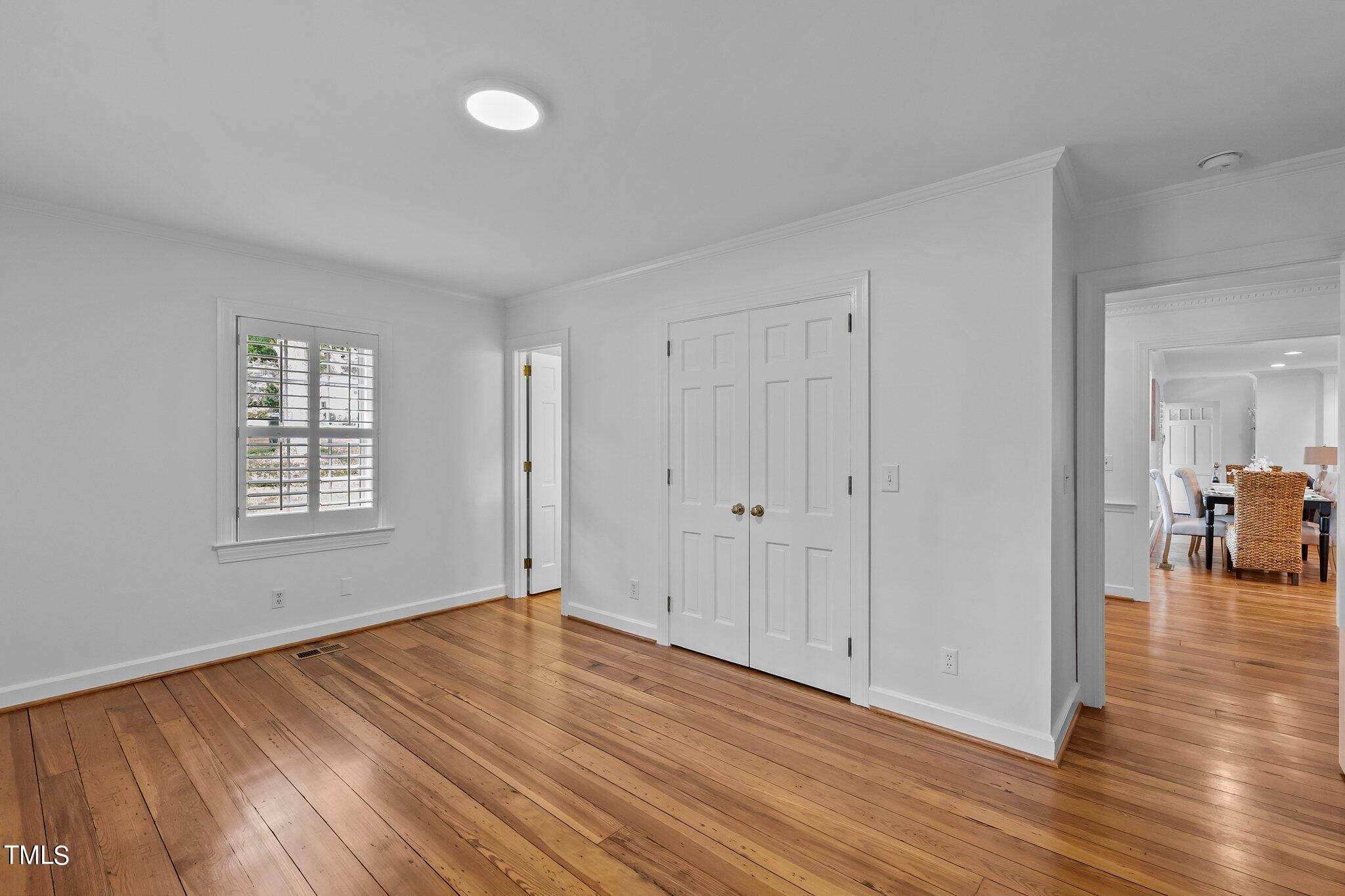 1817 Stillwater Drive Raleigh, NC 27607 - Photo 30 of 58 a view of empty room with wooden floor and fan