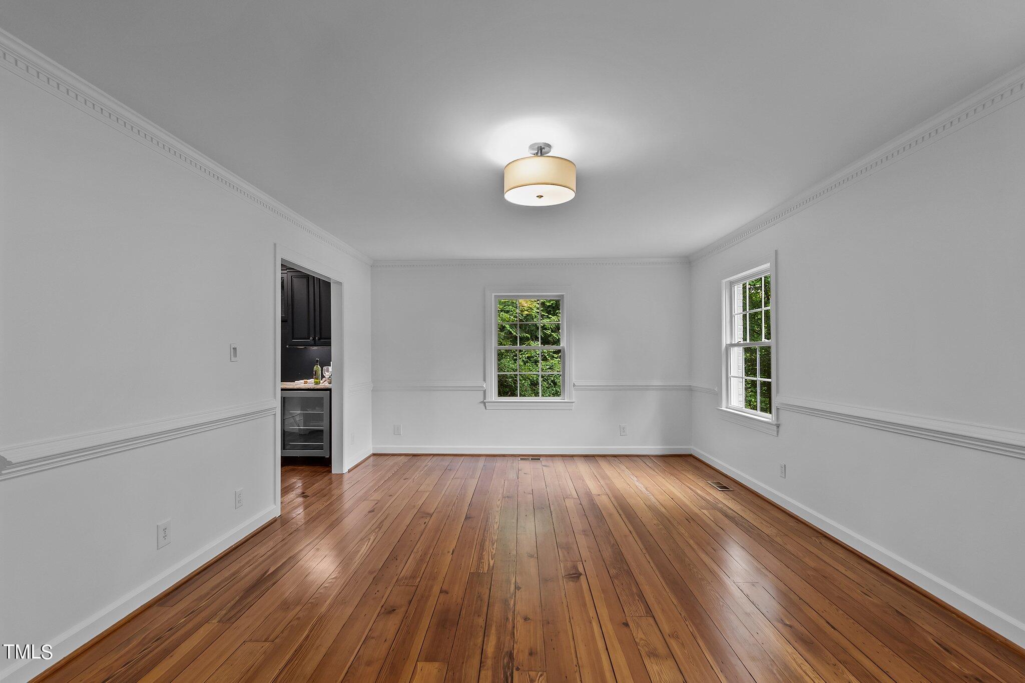 1817 Stillwater Drive Raleigh, NC 27607 - Photo 33 of 58 an empty room with wooden floor and windows