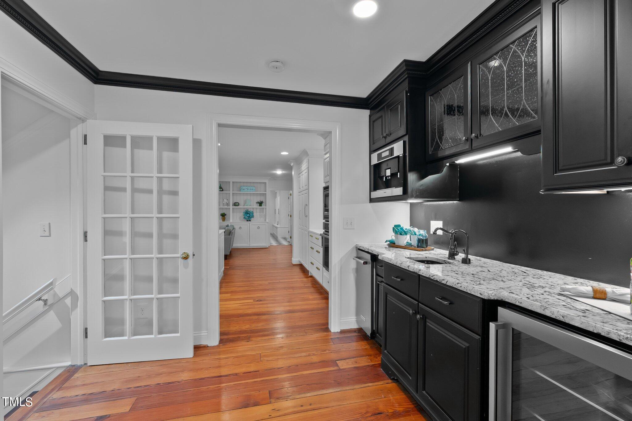 1817 Stillwater Drive Raleigh, NC 27607 - Photo 34 of 58 a kitchen with stainless steel appliances granite countertop a sink stove and cabinets