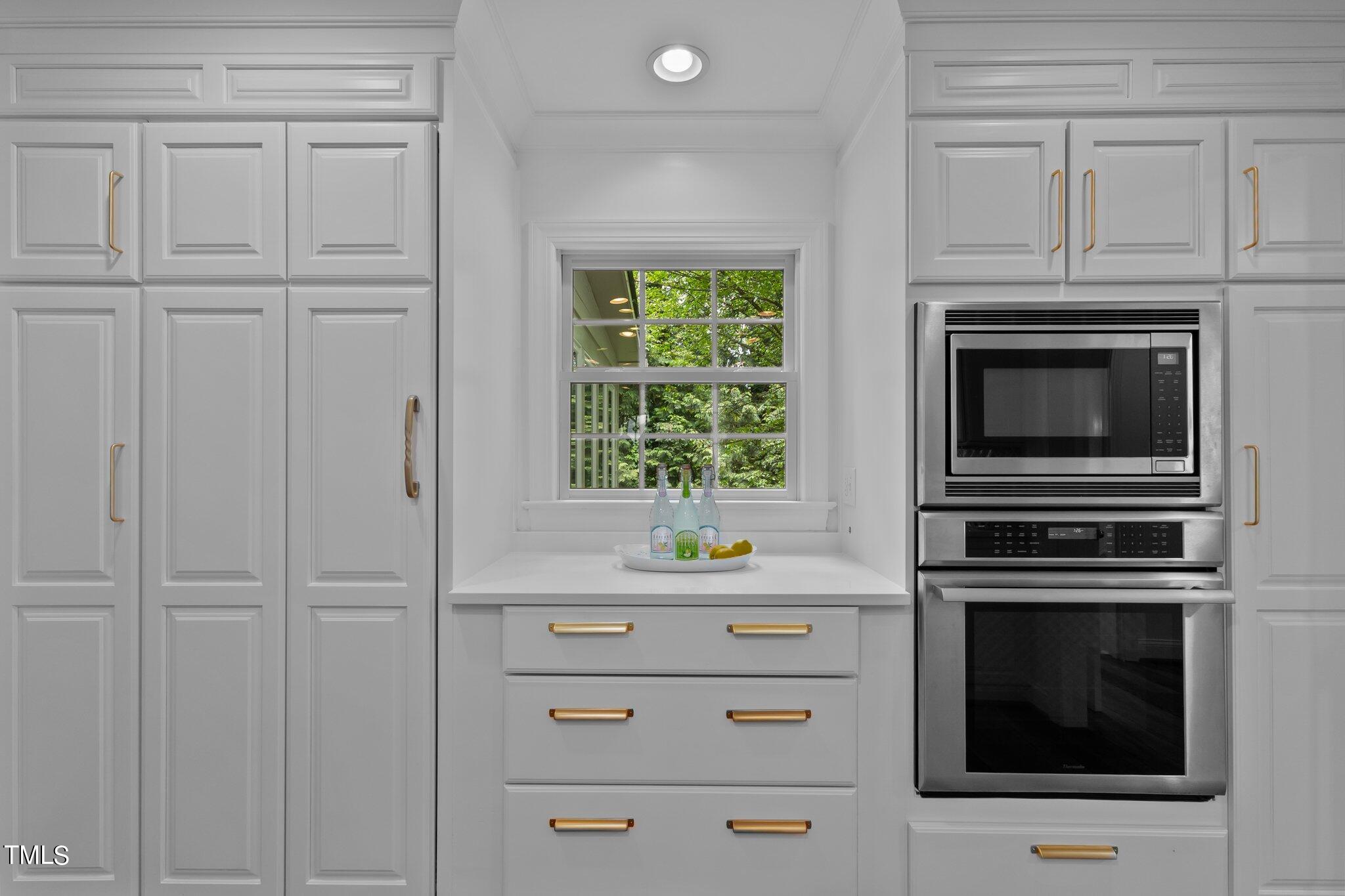 1817 Stillwater Drive Raleigh, NC 27607 - Photo 36 of 58 a kitchen with white cabinets and appliances