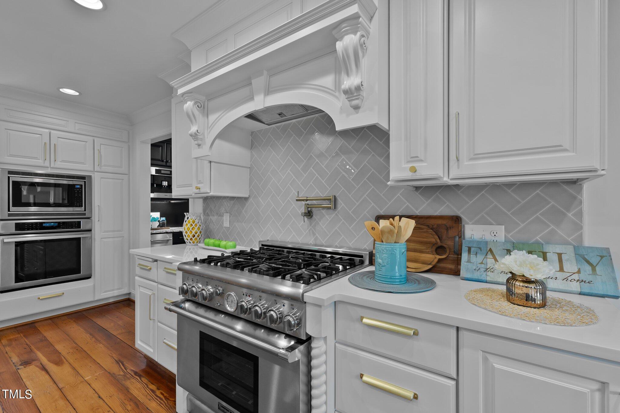 1817 Stillwater Drive Raleigh, NC 27607 - Photo 37 of 58 a kitchen with granite countertop a stove and a sink