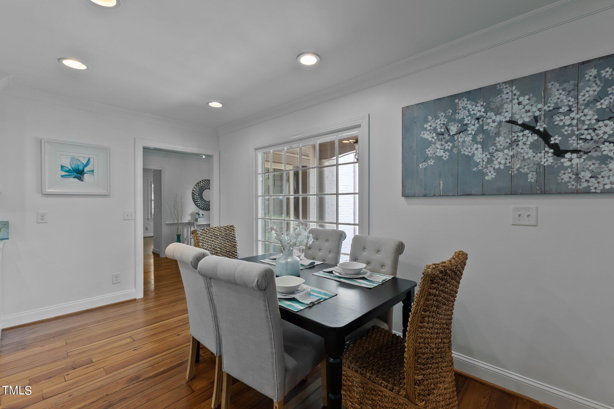 1817 Stillwater Drive Raleigh, NC 27607 - Photo 38 of 58 a view of a dining room with furniture window and wooden floor