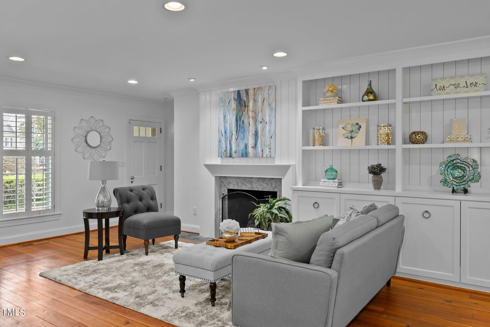 1817 Stillwater Drive Raleigh, NC 27607 - Photo 39 of 58 a living room with furniture and a fireplace
