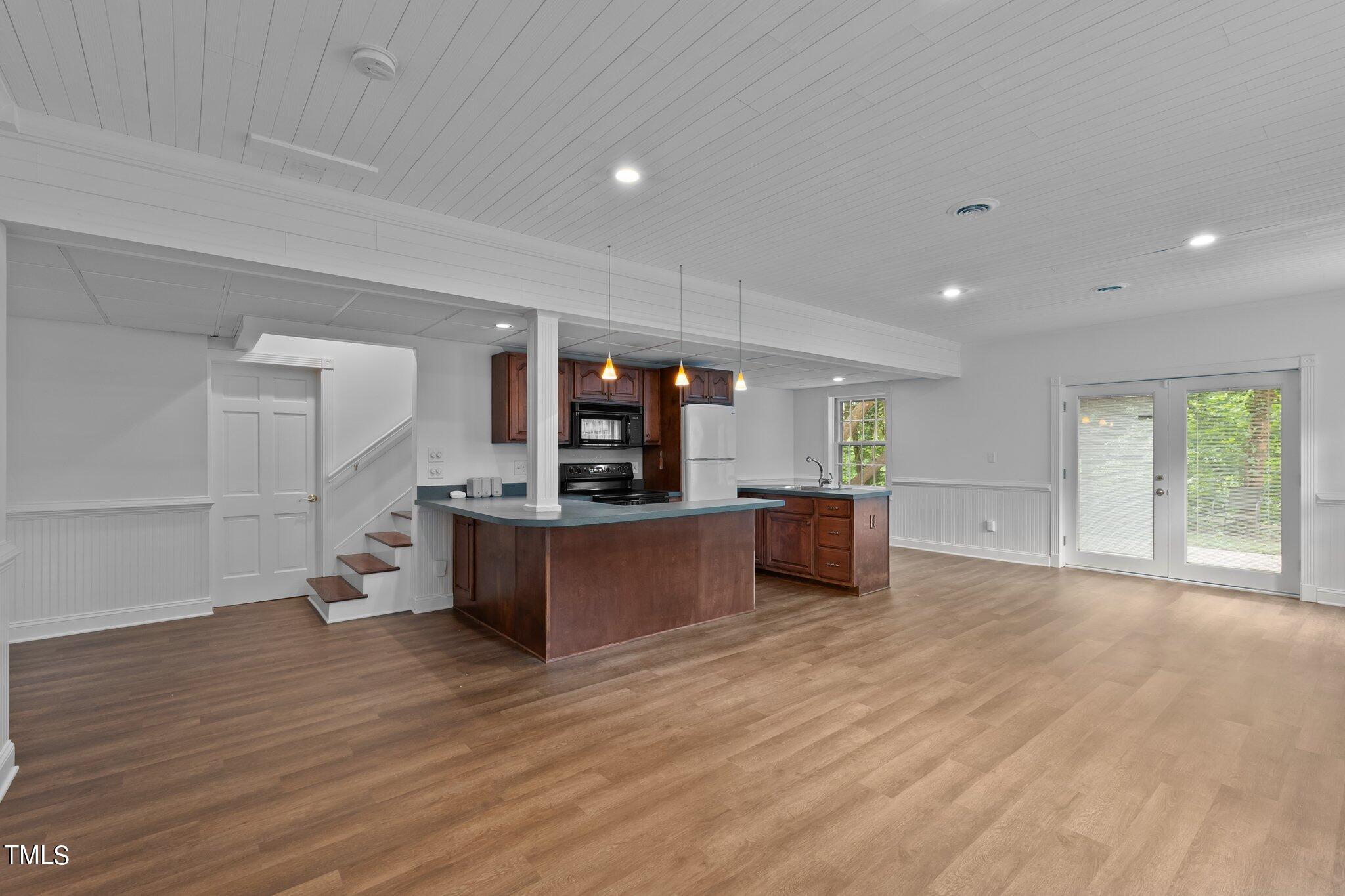 1817 Stillwater Drive Raleigh, NC 27607 - Photo 48 of 58 a living room with furniture and a wooden floor