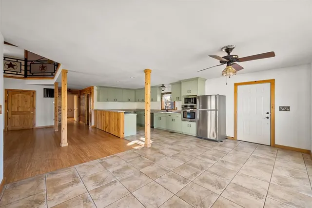 a view of a kitchen with a sink and a refrigerator