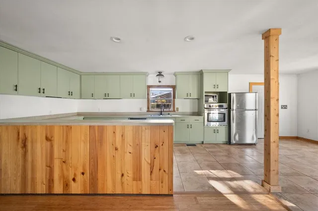 a kitchen with wooden cabinets and refrigerator