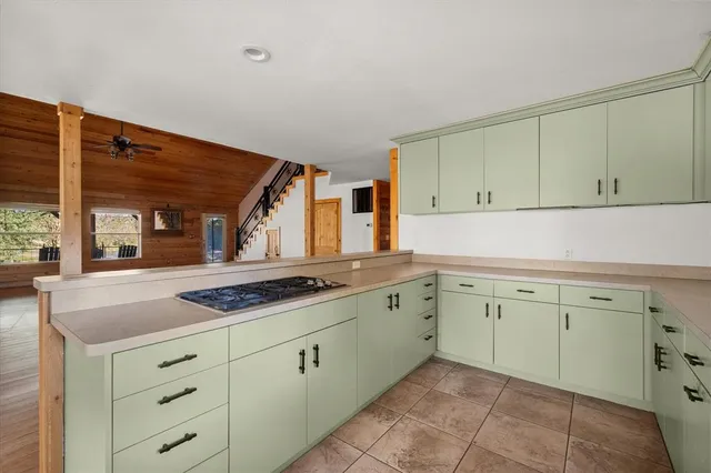 a kitchen with granite countertop white cabinets and white appliances