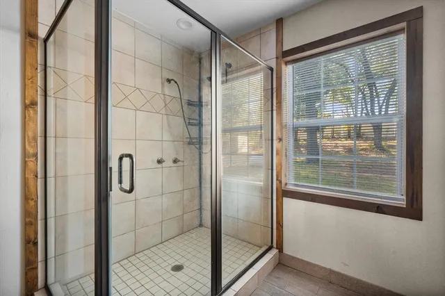 a bathroom with a glass shower door
