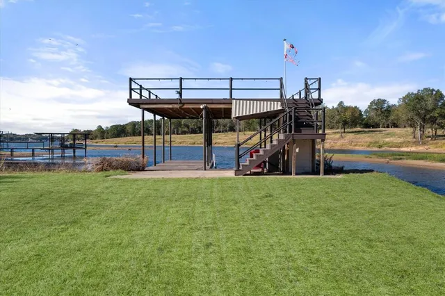 a view of a backyard with a garden and deck