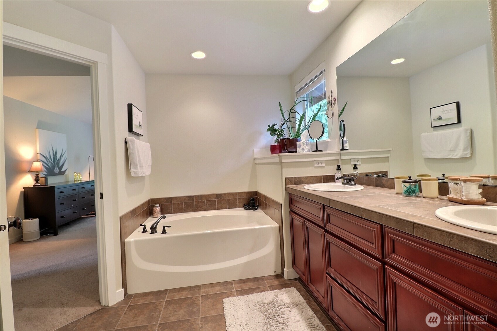 19776 Mountain Ridge Road Southeast Monroe, WA 98272 - Photo 21 of 40 a bath room with a sink and a large mirror