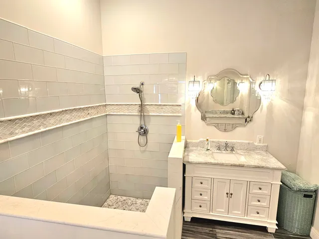 a bathroom with a sink mirror and vanity