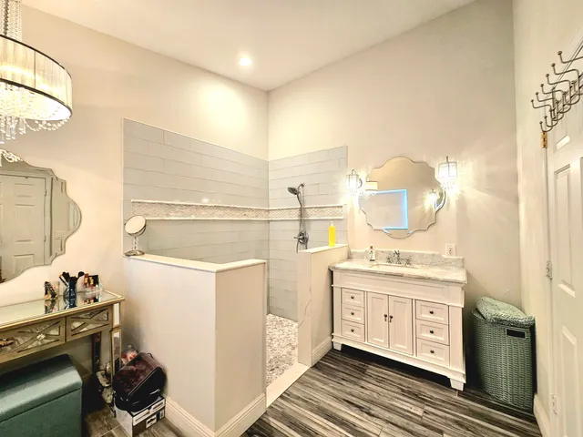 a bathroom with a sink a mirror and vanity