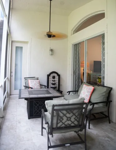 a room with a table chairs and windows