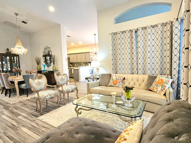 a living room with furniture and a chandelier
