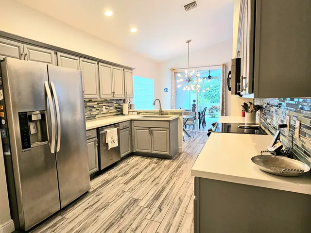 a kitchen with stainless steel appliances a sink stove and refrigerator