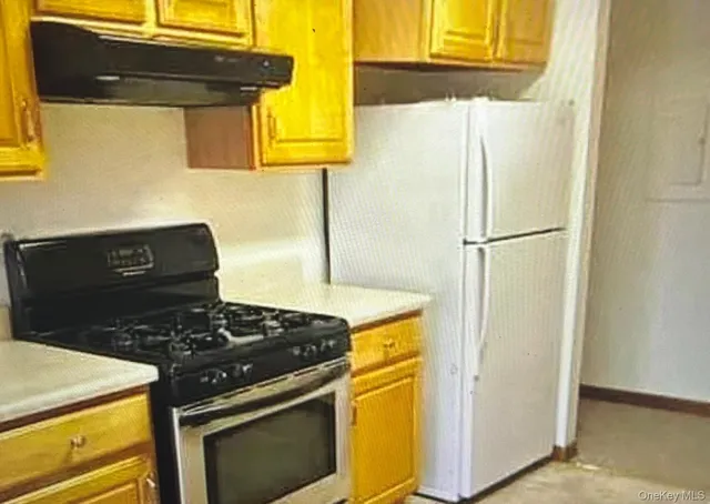 a kitchen with a stove and a refrigerator