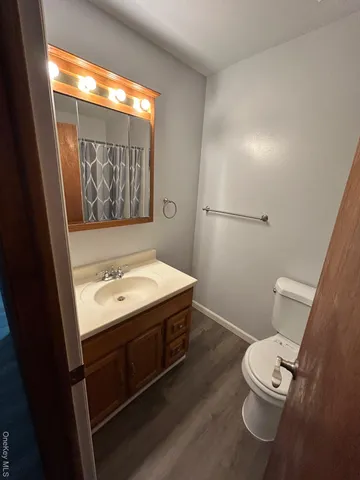 a bathroom with a sink mirror vanity and toilet