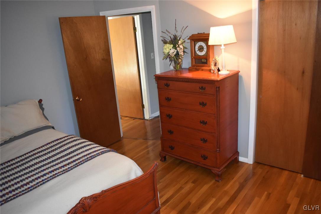 567 Cherry Hill Road Nazareth, PA 18064 - Photo 11 of 14 a bedroom with a bed and wooden floor