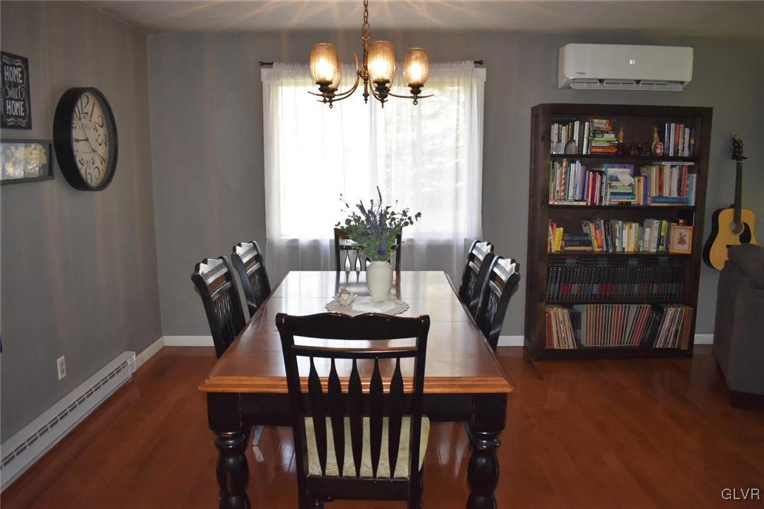 567 Cherry Hill Road Nazareth, PA 18064 - Photo 3 of 14 a dining room with furniture a book shelves and wooden floor