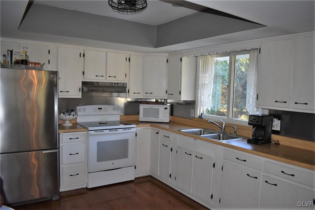 567 Cherry Hill Road Nazareth, PA 18064 - Photo 4 of 14 a kitchen with white cabinets white appliances and sink