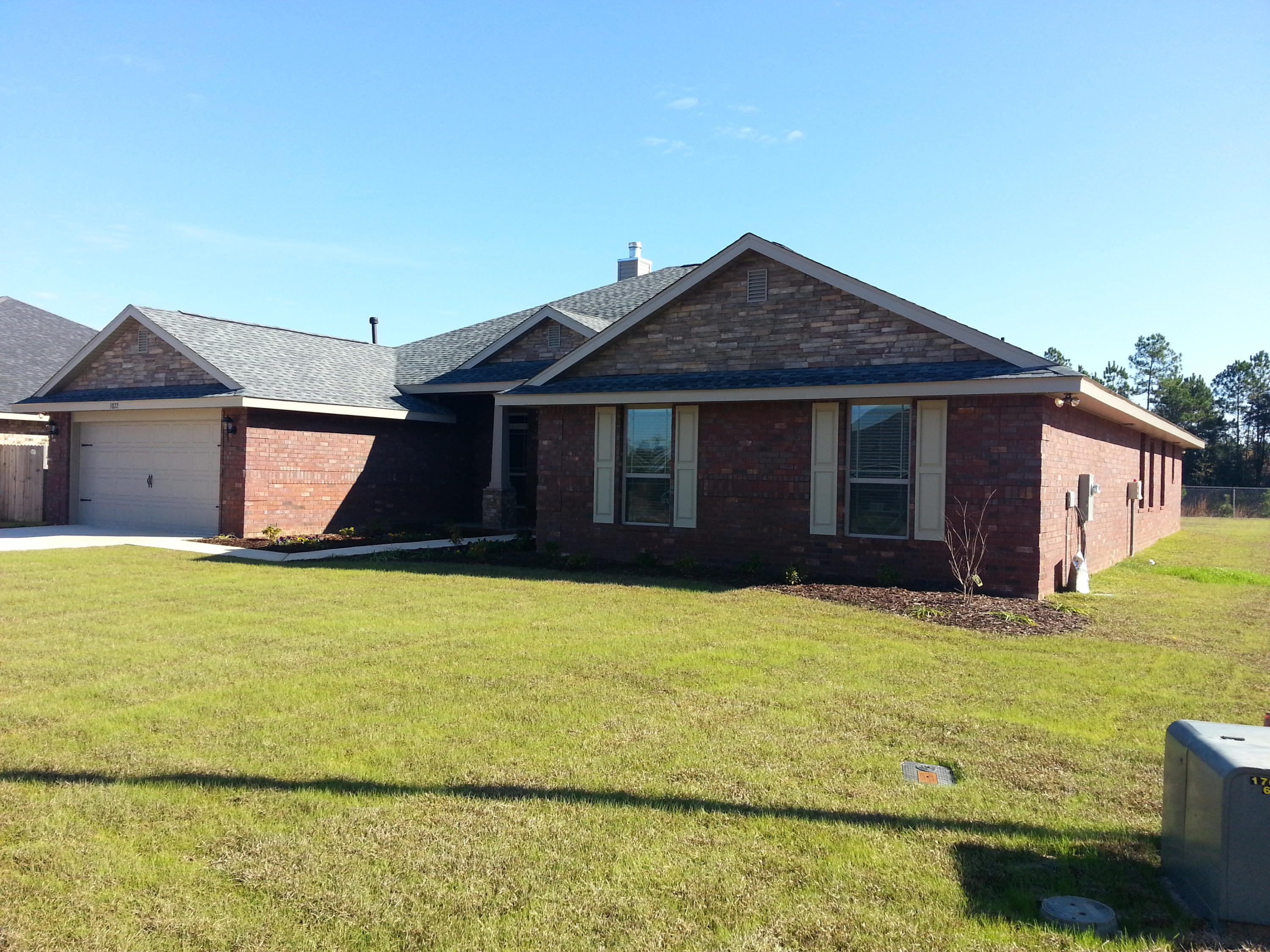 5744 Marigold Loop Crestview, FL 32539 - Photo 1 of 4 a front view of a house with a yard