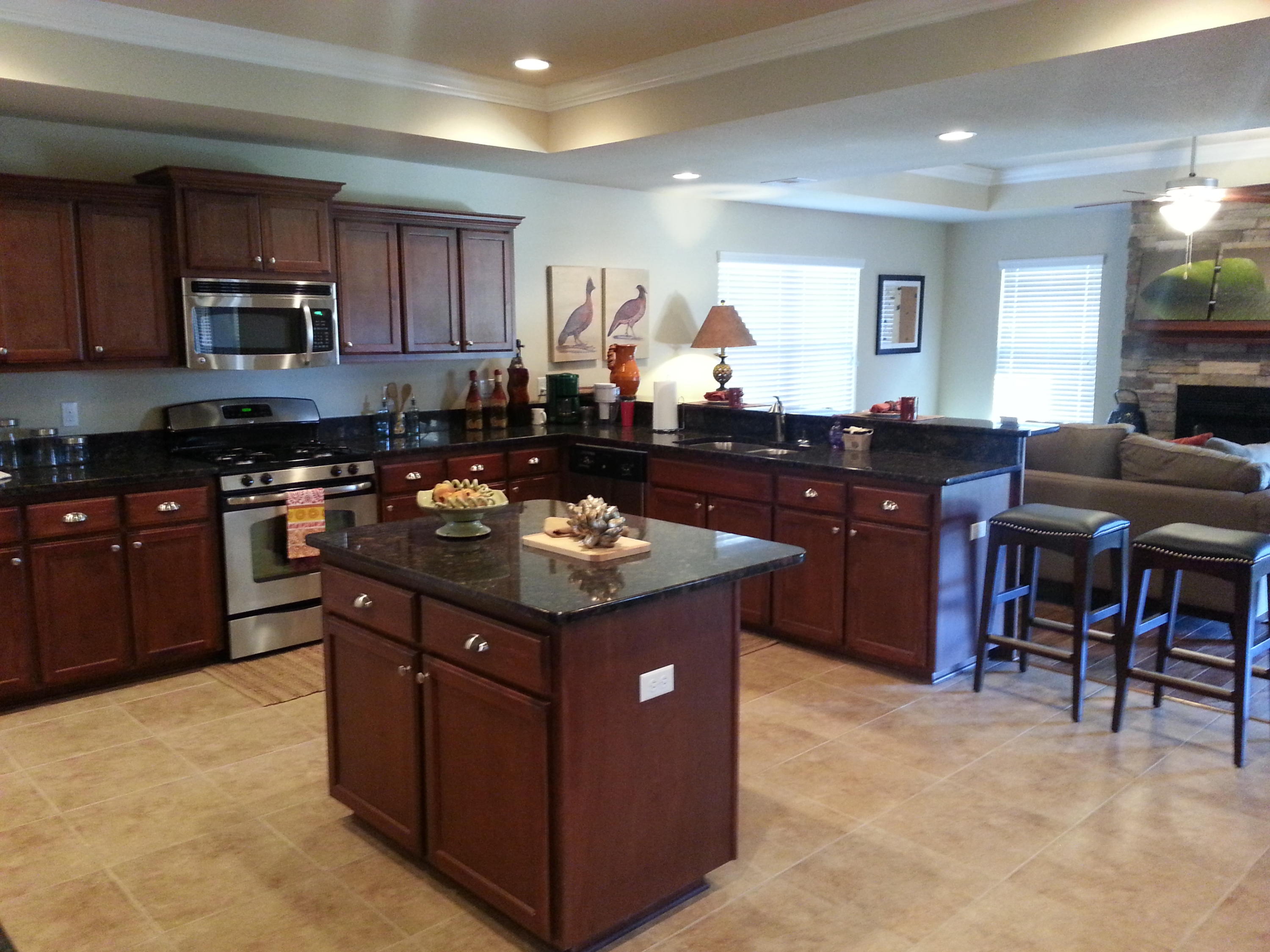 5744 Marigold Loop Crestview, FL 32539 - Photo 3 of 4 a kitchen with kitchen island granite countertop a sink dishwasher stove and cabinets