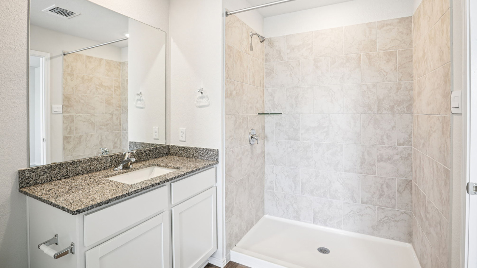133 Wyatt Way Jarrell, TX 76537 - Photo 19 of 32 Bathroom featuring a single vanity with a granite countertop, undermount sink, and a large wall-mounted mirror