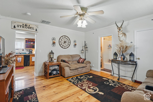 2490 South State Street Springville, UT 84663 - Photo 29 of 38 Living area featuring wood finished floors, visible vents, ceiling fan, and crown molding