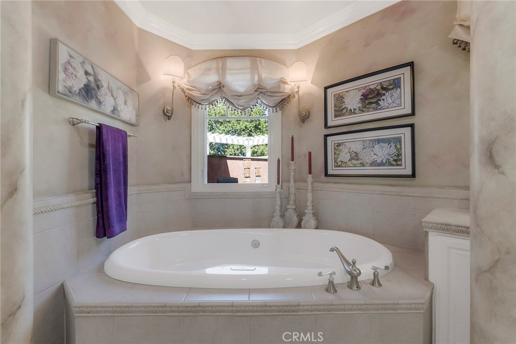 369 Marmore Road Chico, CA 95928 - Photo 29 of 62 a bathroom with a bathtub and a chandelier