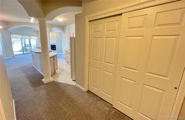 a view of a hallway with wooden shelves