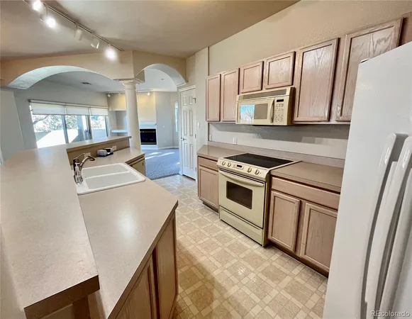 a kitchen with a sink stove and refrigerator