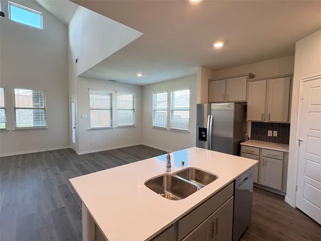 a kitchen with a refrigerator and a sink