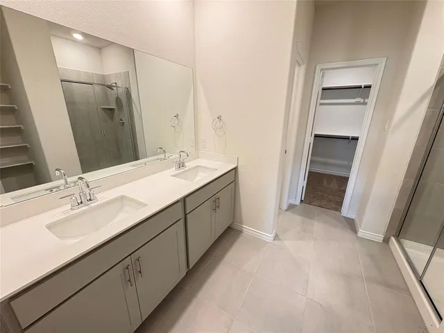 a spacious bathroom with a double vanity sink mirror and