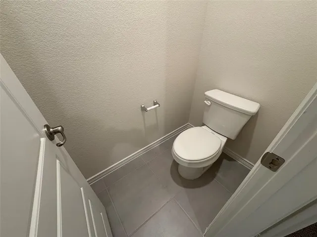 a white toilet sitting next to a shower