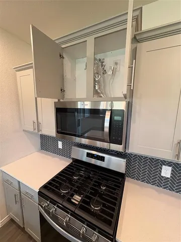 a kitchen with a stove and a microwave