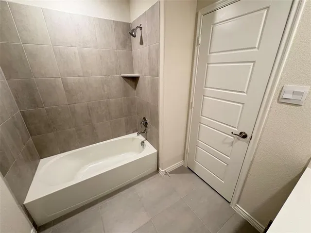 a bathroom with a tub and shower