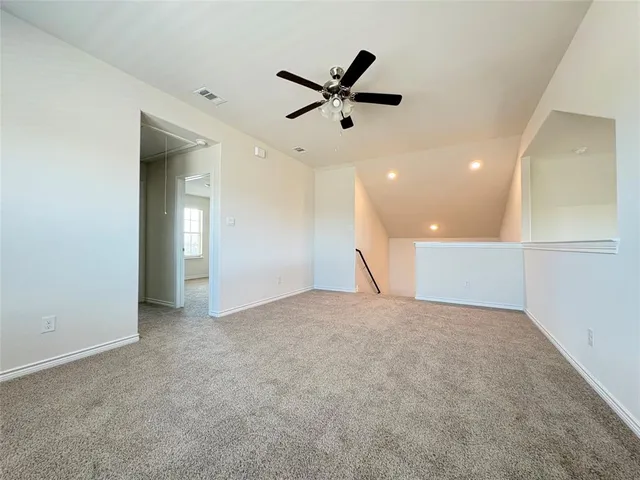 a view of a livingroom with a ceiling fan and window