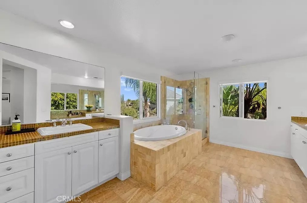 44840 Tudal Street Temecula, CA 92592 - Photo 16 of 35 a spacious bathroom with a granite countertop sink and a large mirror
