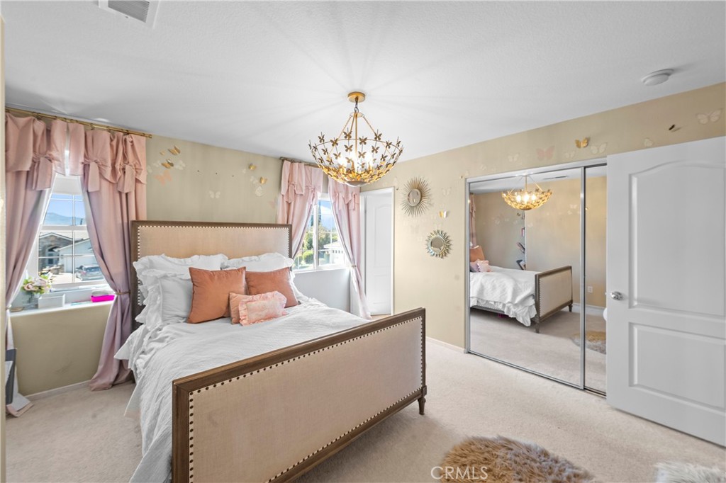 44840 Tudal Street Temecula, CA 92592 - Photo 17 of 35 a bedroom with a bed and a chandelier