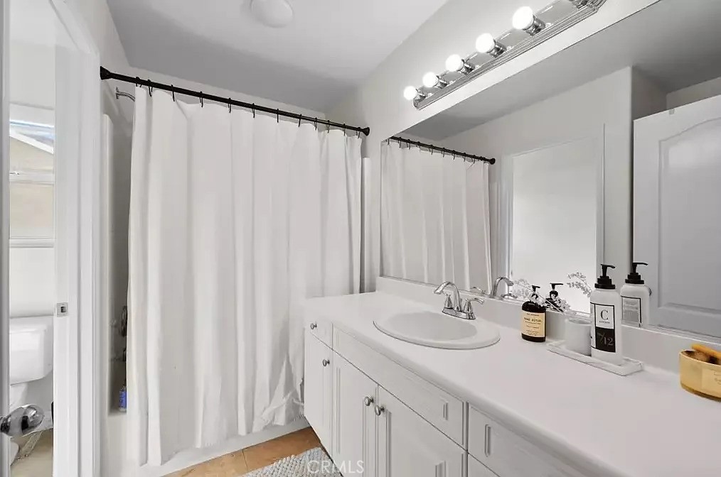 44840 Tudal Street Temecula, CA 92592 - Photo 21 of 35 a bathroom with a double vanity sink and a mirror