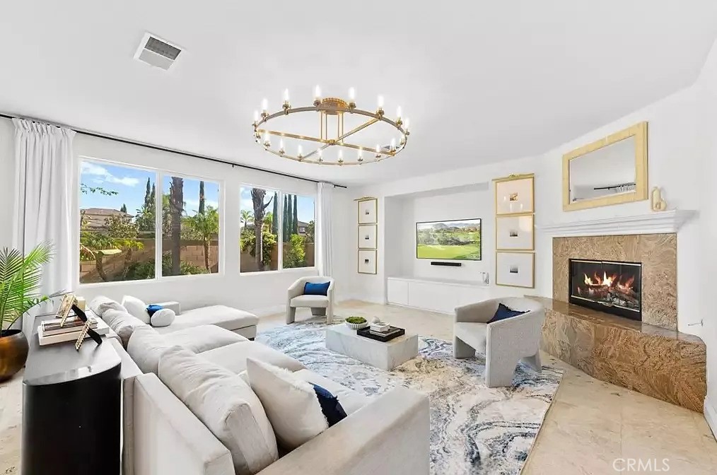 44840 Tudal Street Temecula, CA 92592 - Photo 7 of 35 a living room with furniture chandelier and a fireplace