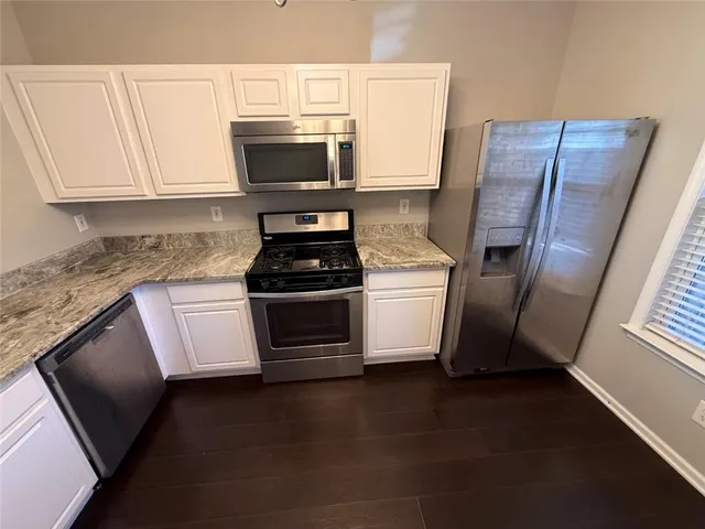 a kitchen with a sink and steel appliances