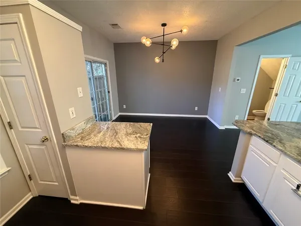 a view of a kitchen from a hallway