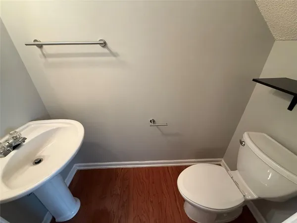 a bathroom with a toilet and a mirror