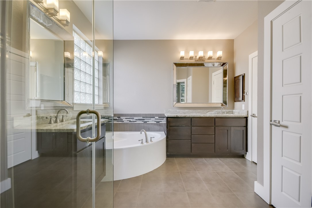 3513 Grimes Ranch Road Austin, TX 78732 - Photo 11 of 32 Full bath featuring a garden tub, tile patterned floors, and vanity