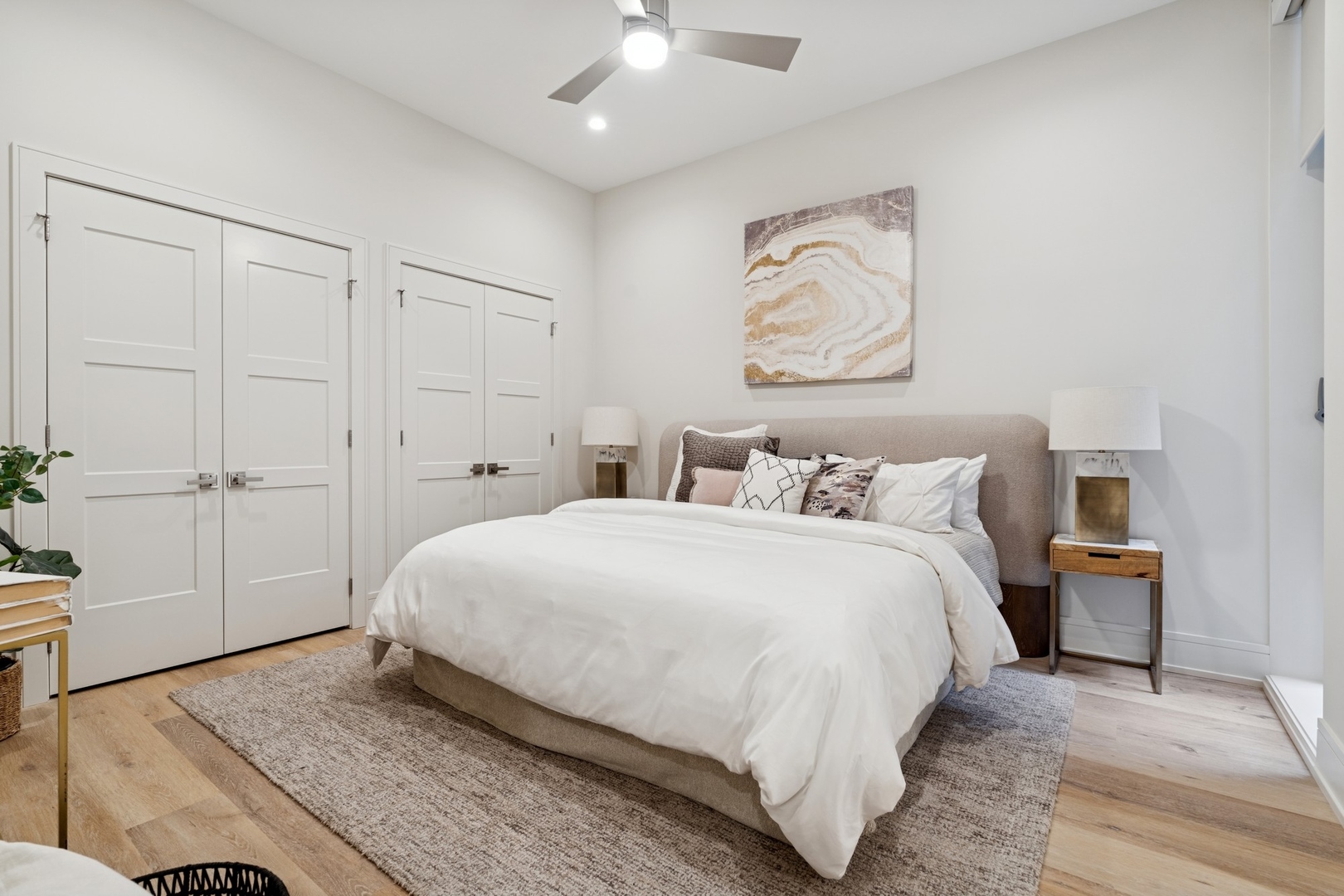 3951 North Wayne Avenue, Unit 101 Chicago, IL 60613 - Photo 11 of 18 a bedroom with a bed and a chandelier