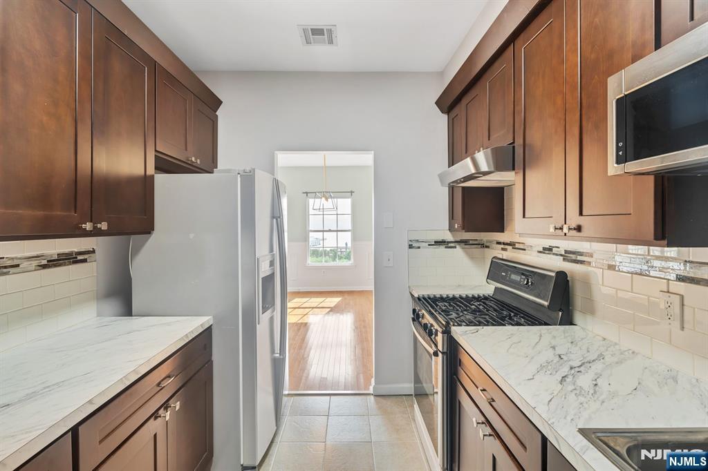 66 Bergen Ridge Road, Unit 1 North Bergen, NJ 07047 - Photo 13 of 26 a kitchen with stainless steel appliances granite countertop a sink stove and refrigerator