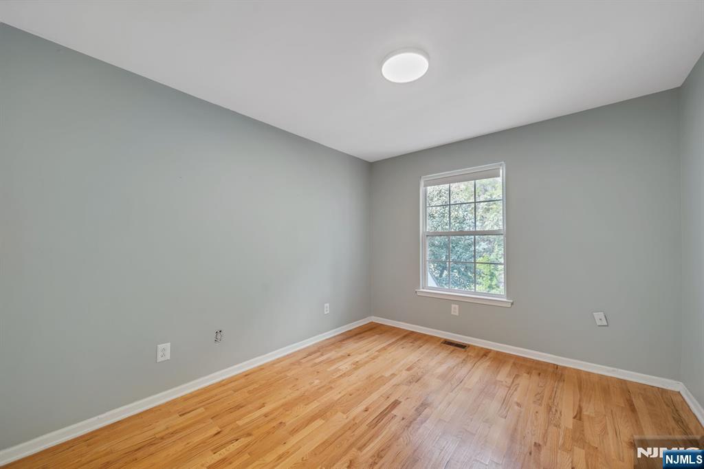 66 Bergen Ridge Road, Unit 1 North Bergen, NJ 07047 - Photo 19 of 26 an empty room with wooden floor and windows