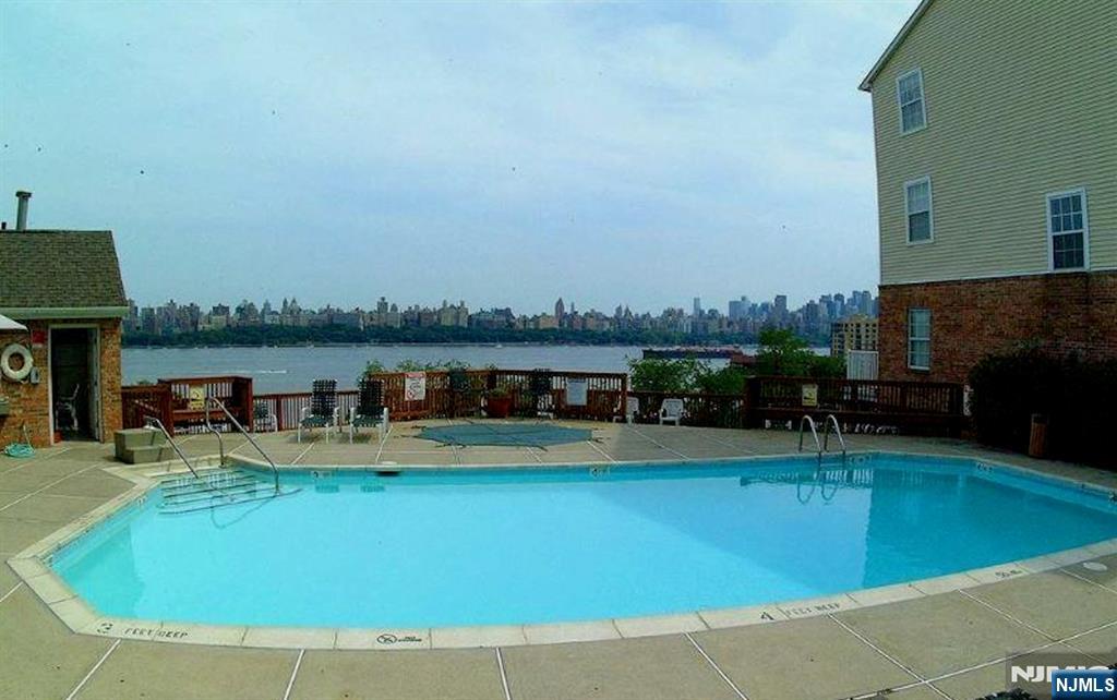 66 Bergen Ridge Road, Unit 1 North Bergen, NJ 07047 - Photo 5 of 26 a view of a swimming pool with lawn chairs and a yard